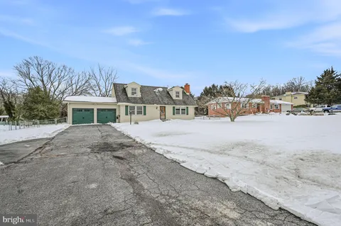 a view of house with a yard and covered with snow