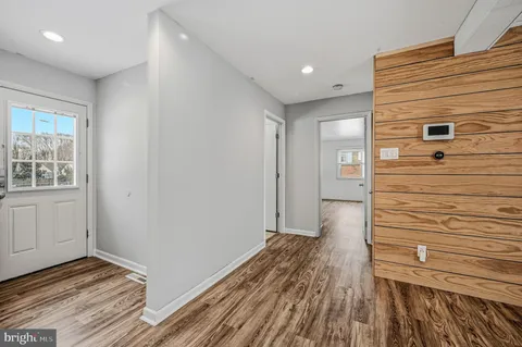 a view of hallway with wooden floor