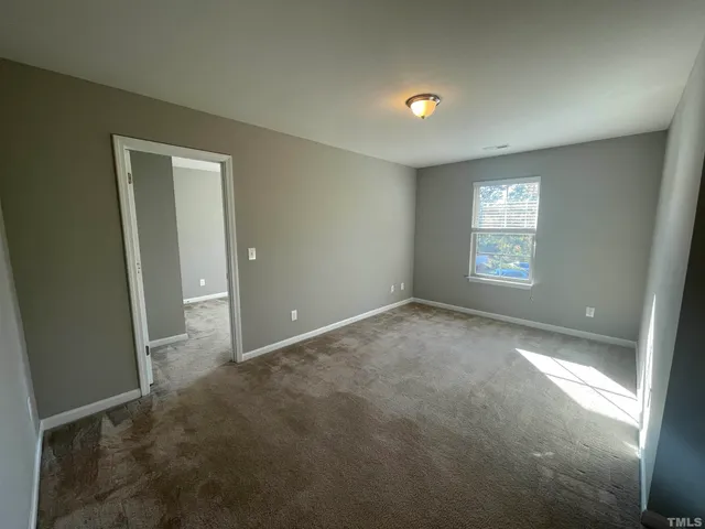 en empty room with windows and closet