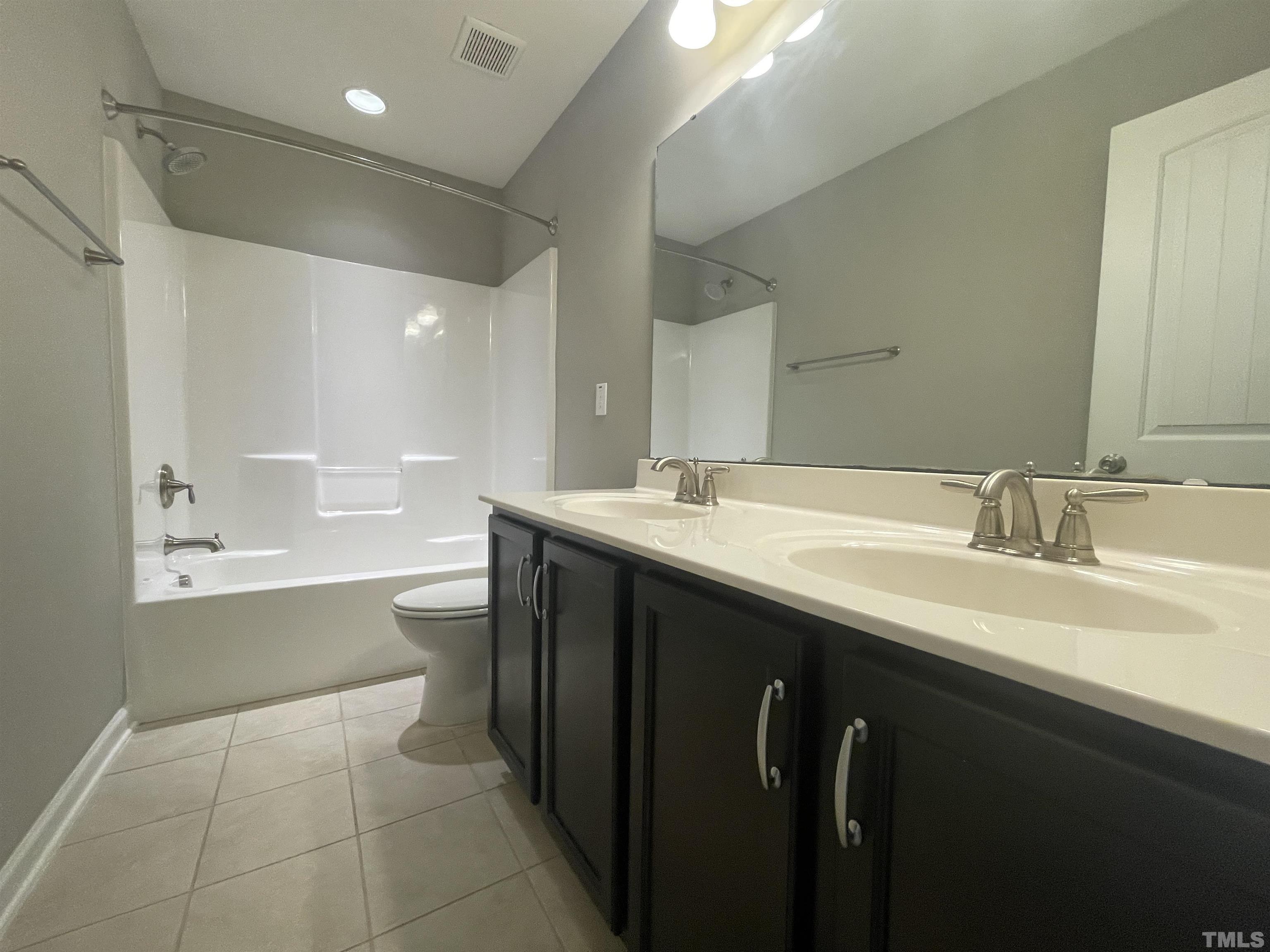 3928 Valley Side Court Cary, NC 27519 - Photo 17 of 26 a bathroom with a sink double vanity and a bathtub