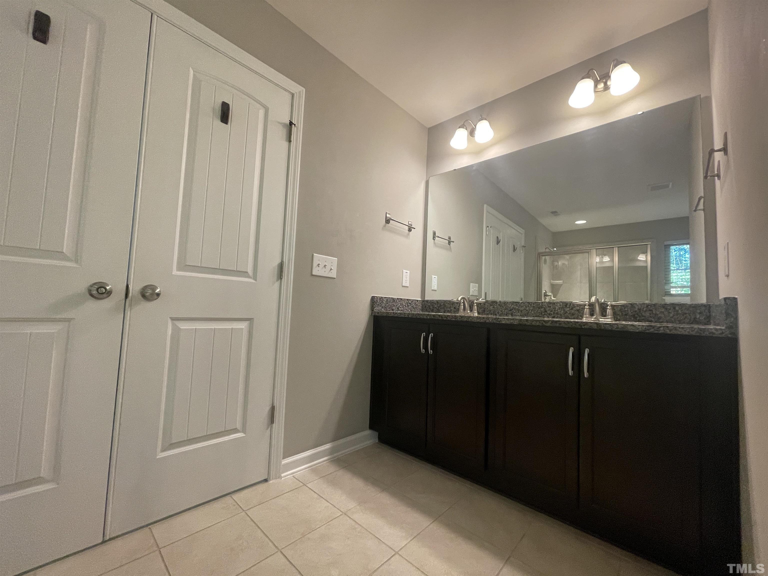 3928 Valley Side Court Cary, NC 27519 - Photo 24 of 26 a bathroom with a sink vanity and a mirror