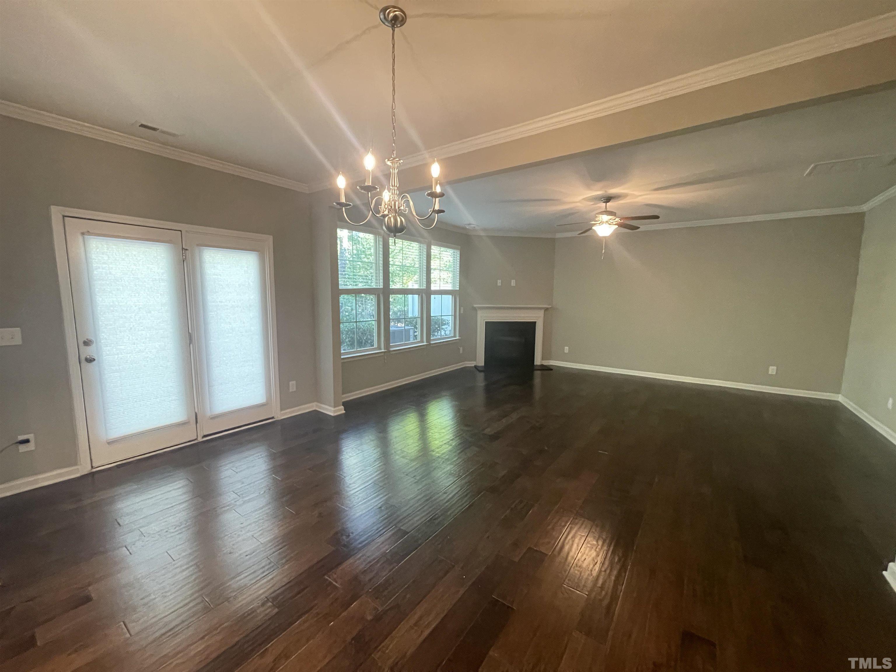 3928 Valley Side Court Cary, NC 27519 - Photo 6 of 26 a view of an empty room with wooden floor and a window