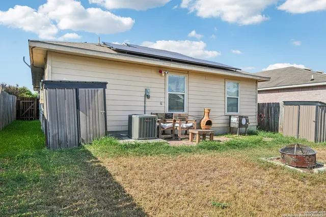 a view of a backyard with chairs and a patio