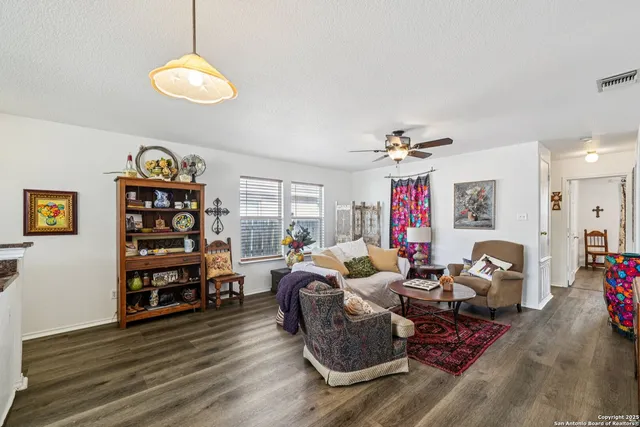 a living room with furniture and wooden floor