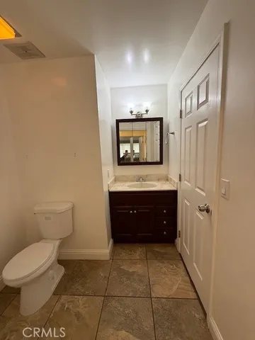a bathroom with a toilet a sink and a mirror