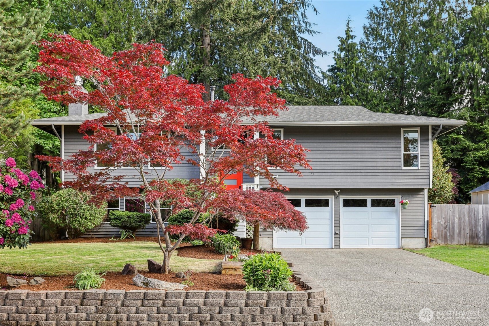 a front view of a house with a garden