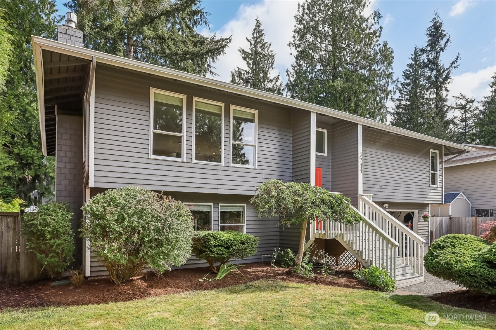 2711 164th Place Southeast Bothell, WA 98012 - Photo 2 of 26 a front view of a house with garden