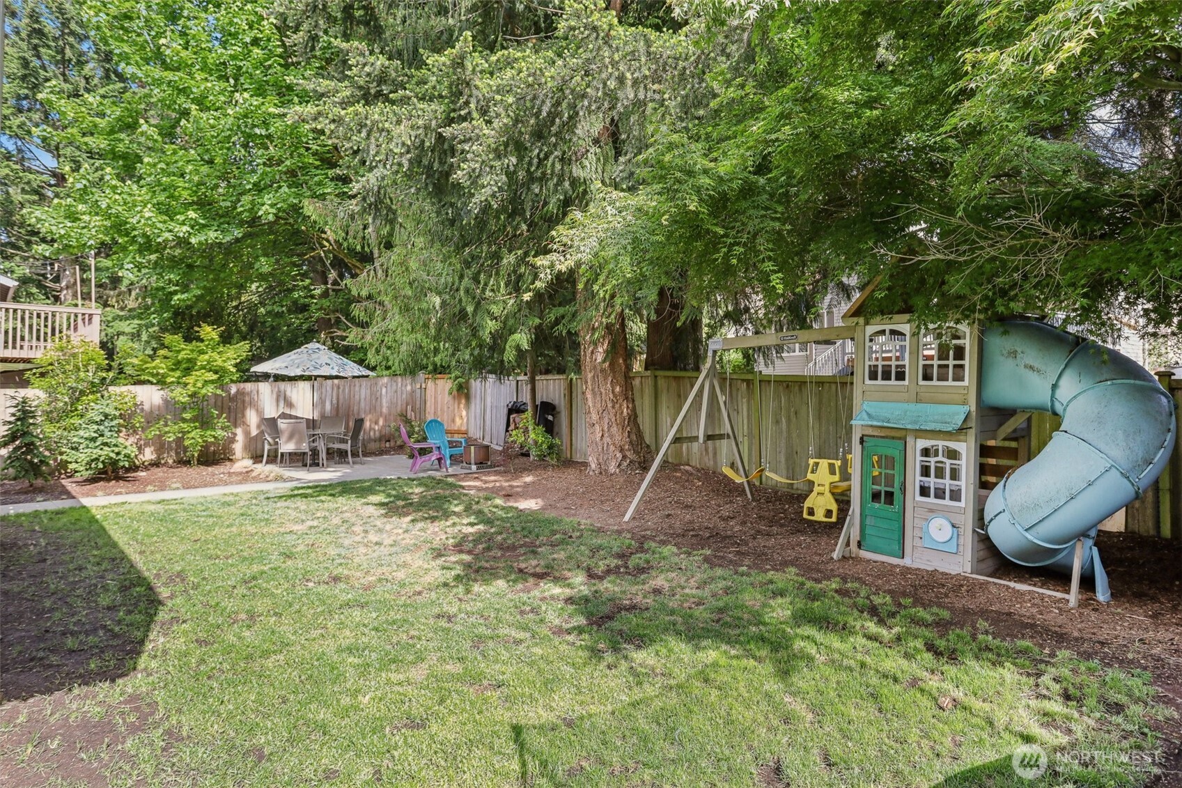 2711 164th Place Southeast Bothell, WA 98012 - Photo 24 of 26 a view of a backyard with a table and chairs and a large tree