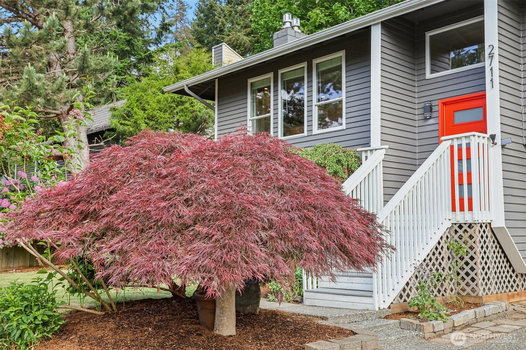 2711 164th Place Southeast Bothell, WA 98012 - Photo 3 of 26 a front view of a house with garden