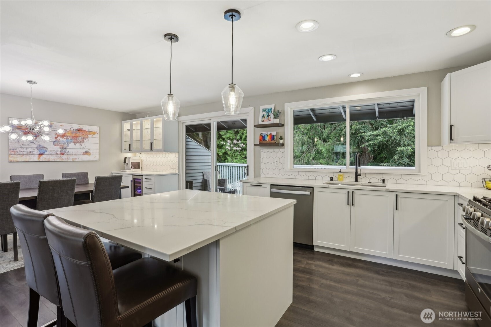 2711 164th Place Southeast Bothell, WA 98012 - Photo 8 of 26 a open dining room with stainless steel appliances granite countertop a kitchen island a stove a table a sink and a large window