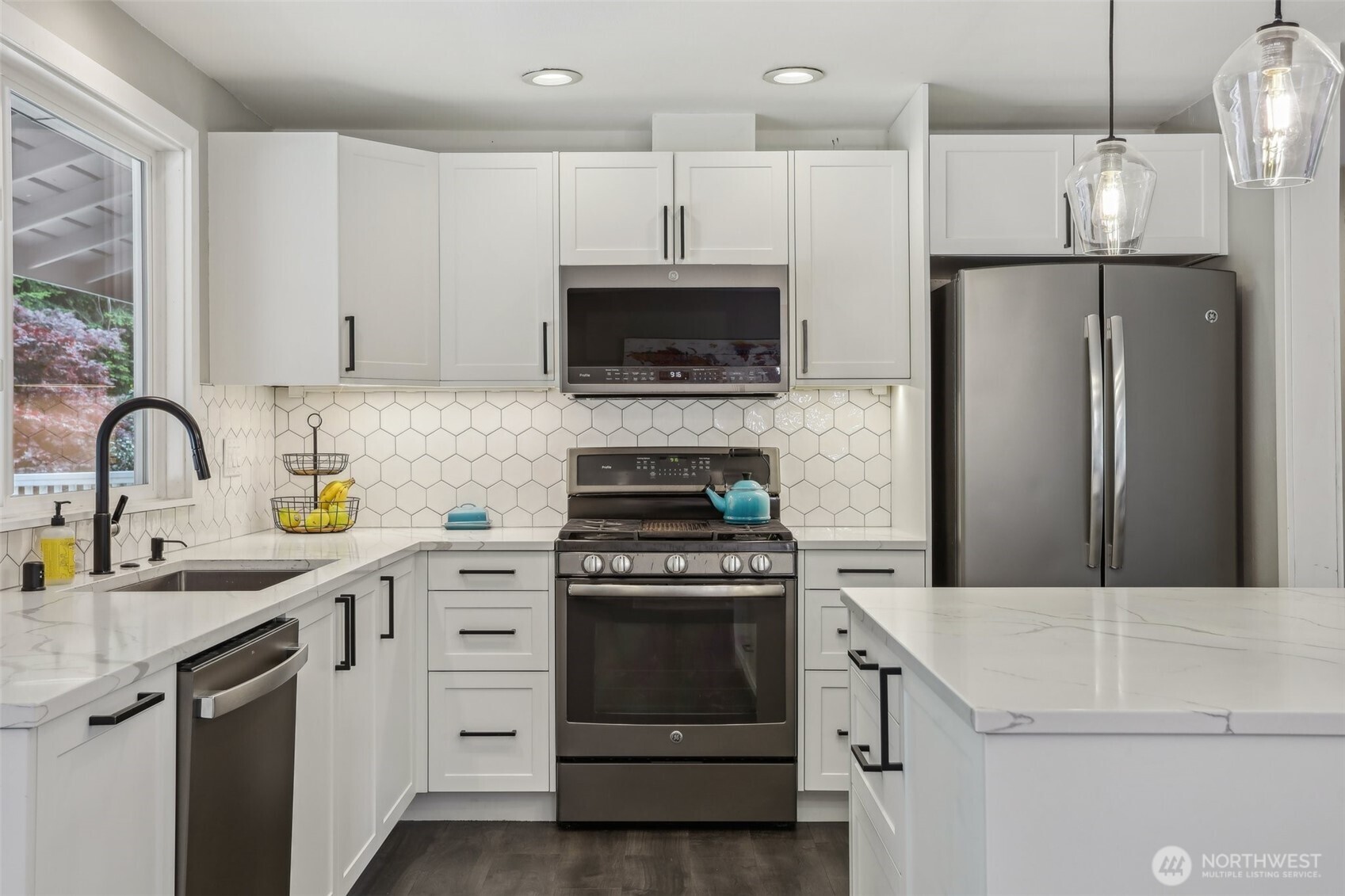 2711 164th Place Southeast Bothell, WA 98012 - Photo 9 of 26 a kitchen with a sink stove and refrigerator