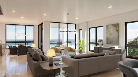 a living room with furniture and large windows