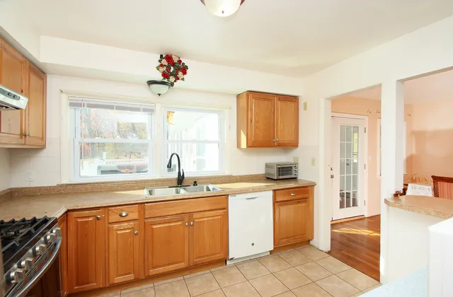 a kitchen with a sink stove and cabinets