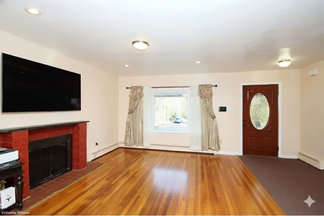 a view of a livingroom with an empty space and a fireplace