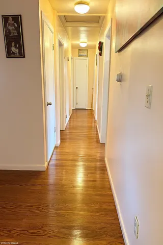 a view of a hallway with wooden floor