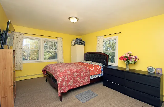 a bedroom with a bed and a window