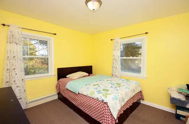 a bedroom with a bed and window