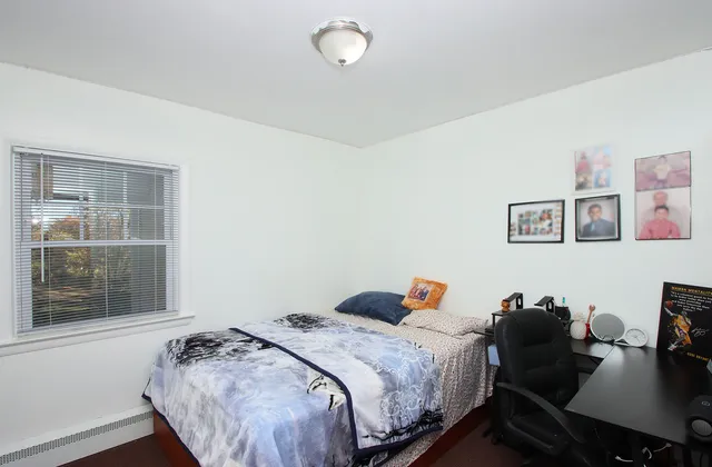 a bed room with a bed window and a table