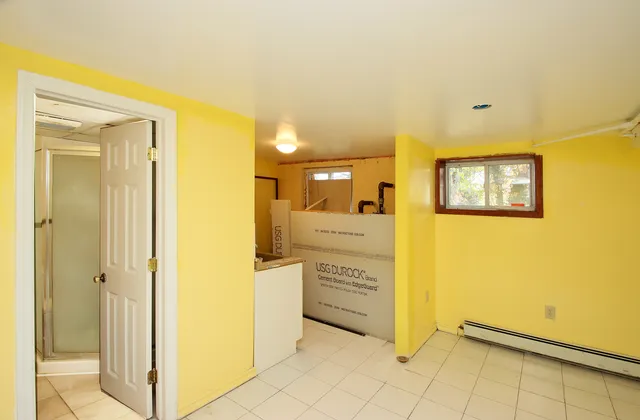 a view of a hallway with a dining table and chairs