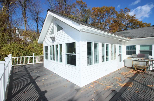 a view of a house with backyard and sitting area