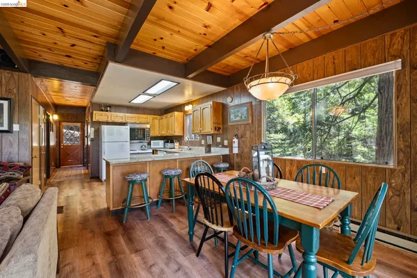 a dining room with furniture and wooden floor