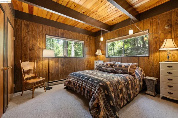 a bed sitting in a bedroom next to a window