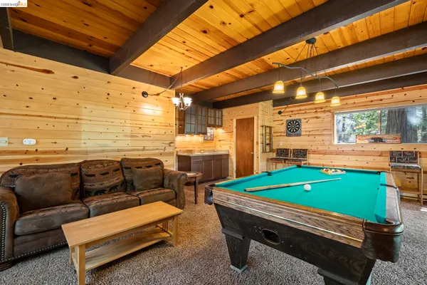 a backyard of a house with barbeque oven table and chairs