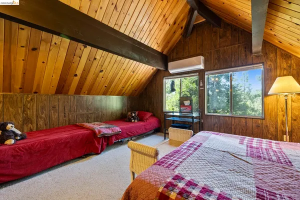 a bedroom with two beds and a window