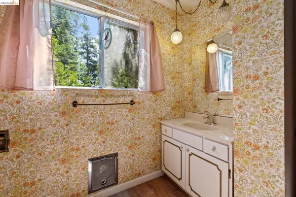 a bathroom with a sink a vanity and a mirror