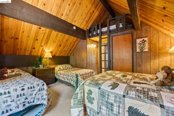 a bedroom with two beds and a window