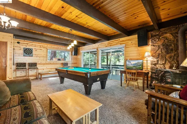 a room with pool table table and chairs