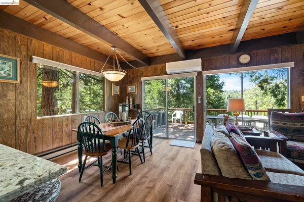 a view of a dining room with furniture wooden floor and fan