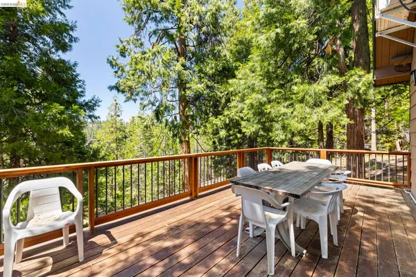 a balcony with wooden floor and outdoor seating