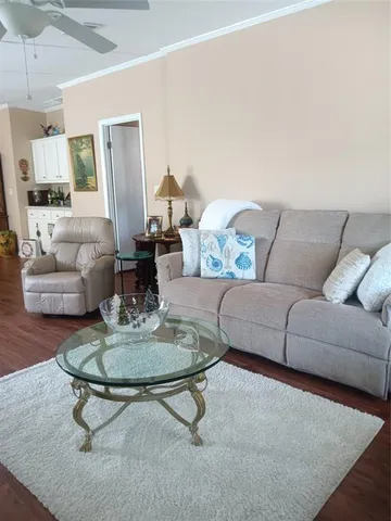 a living room with furniture a rug and a table