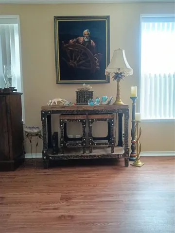 a living room with furniture a fireplace and a large window