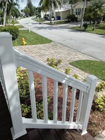 a living room with a mirror and a wooden floor
