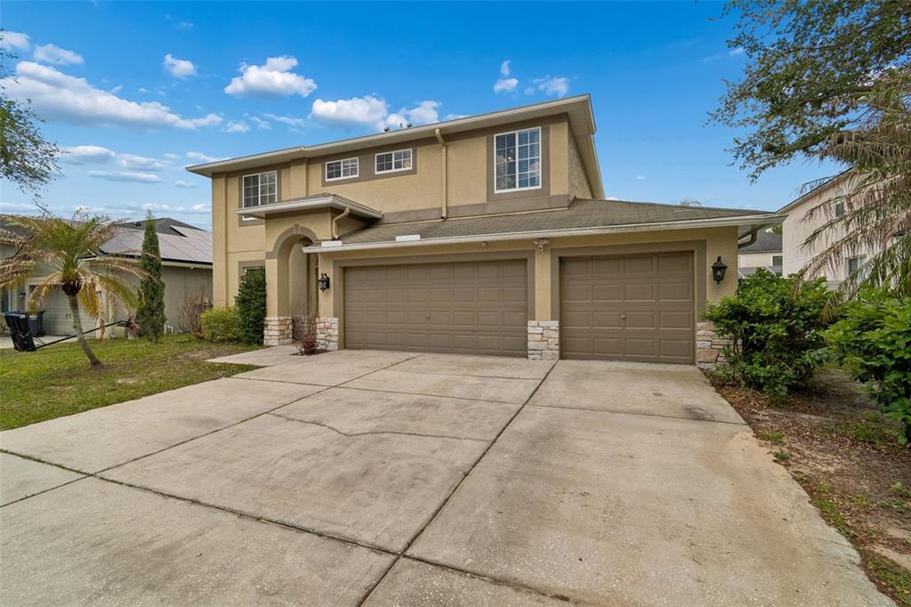 2829 Pankaw Lane Valrico, FL 33596 - Photo 2 of 55 a front view of a house with a yard and garage
