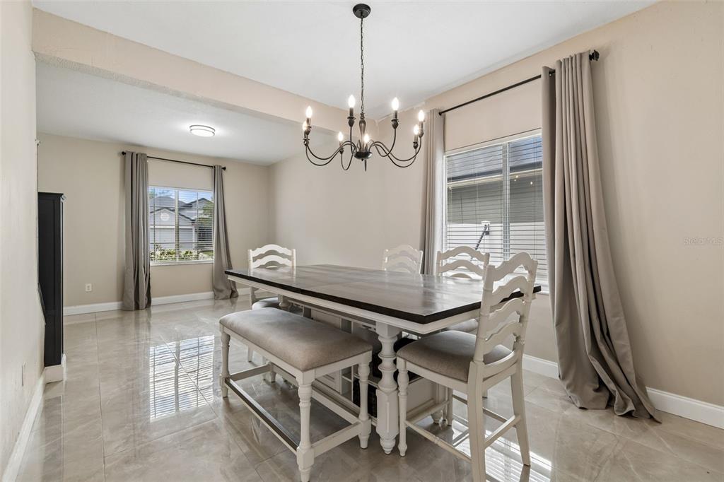 2829 Pankaw Lane Valrico, FL 33596 - Photo 9 of 55 a view of a dining room with furniture and a chandelier