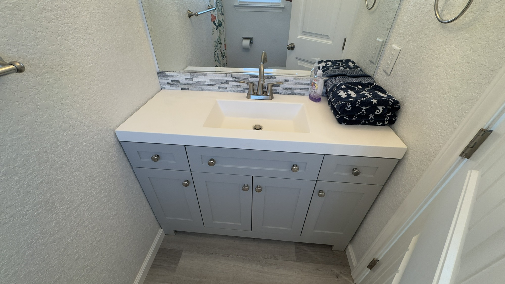 317 Olive Street Surfside Beach, TX 77541 - Photo 12 of 22 a bathroom with a sink and a mirror