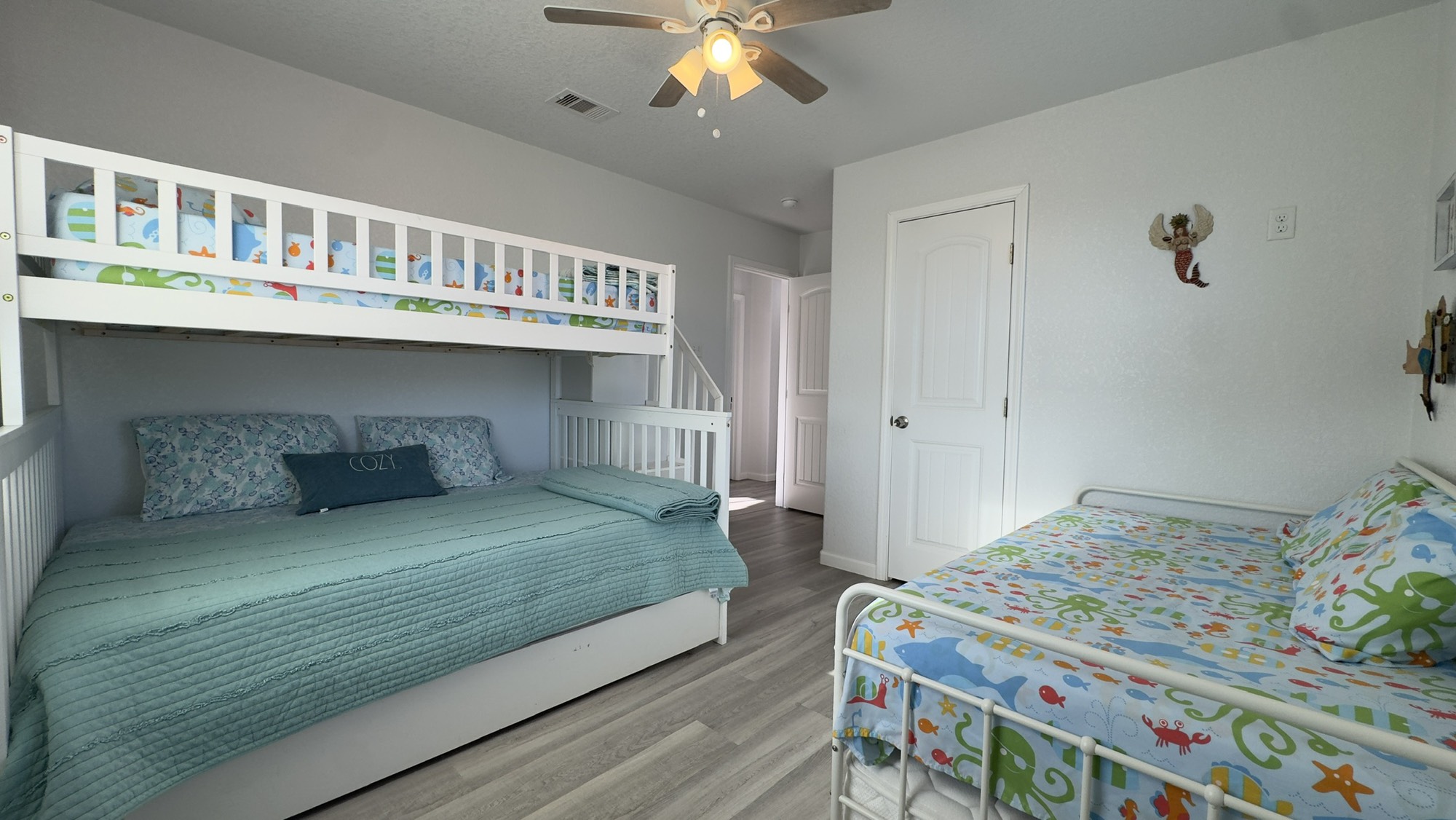317 Olive Street Surfside Beach, TX 77541 - Photo 16 of 22 a bedroom with a bed and a chandelier