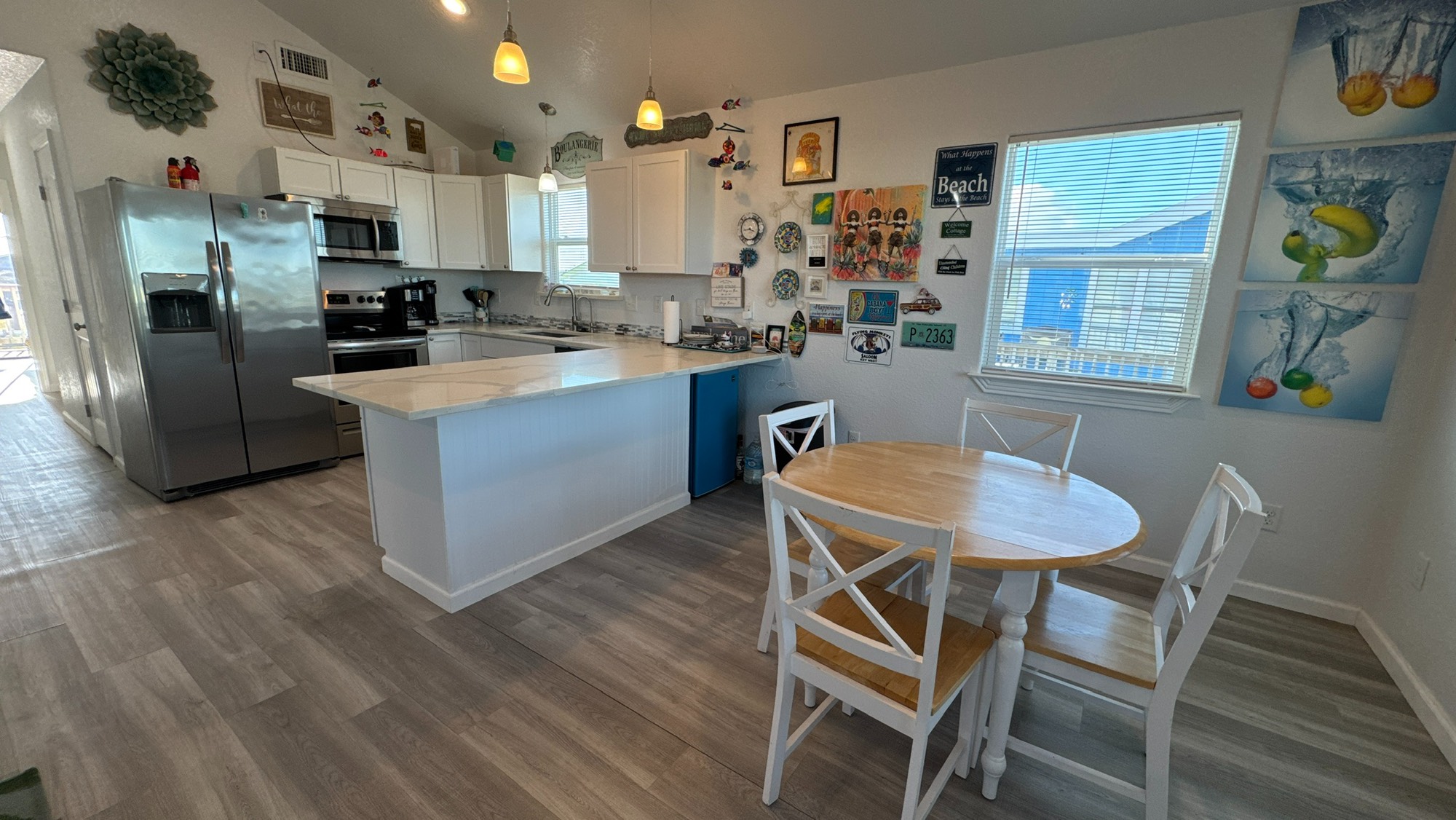 317 Olive Street Surfside Beach, TX 77541 - Photo 8 of 22 a kitchen with stainless steel appliances granite countertop a kitchen island hardwood floor and a sink