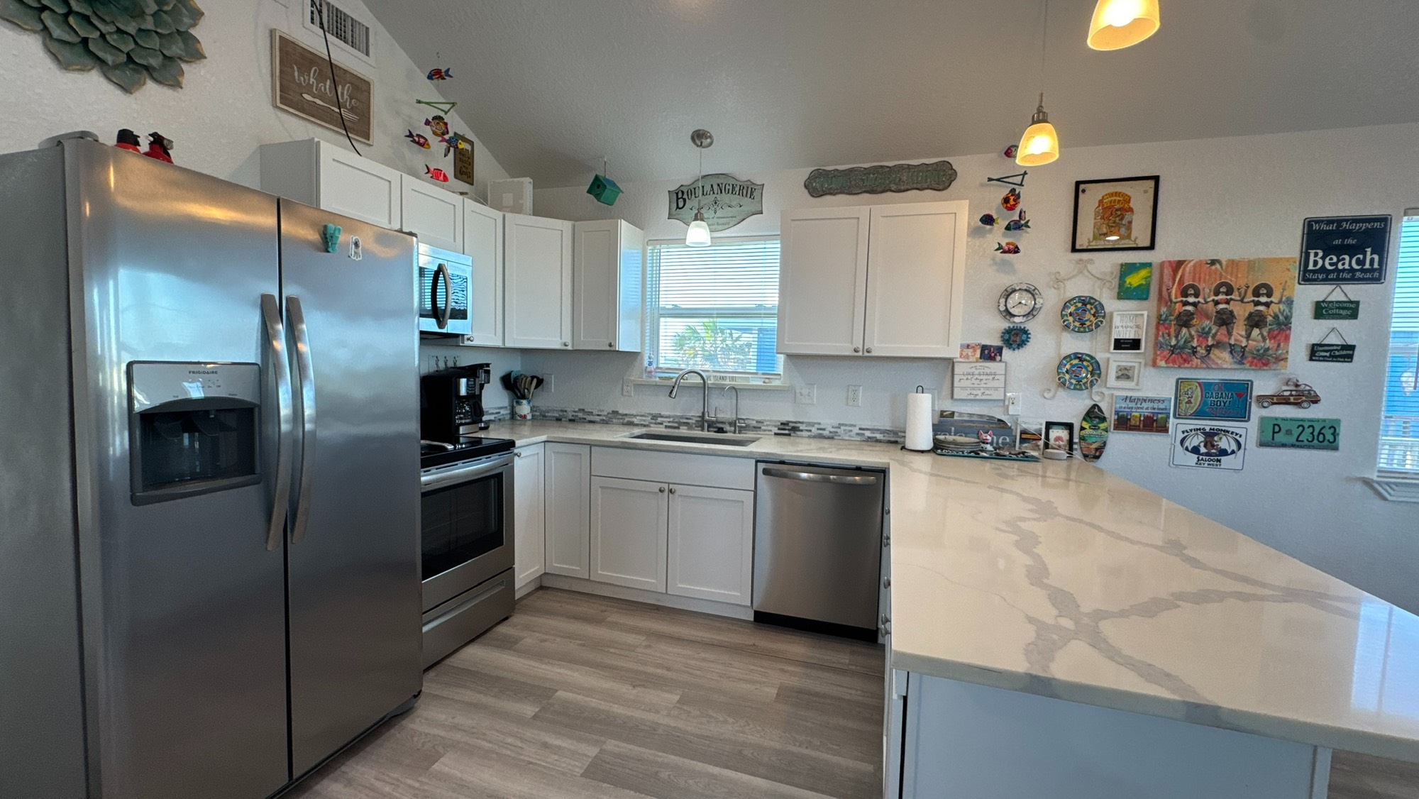 317 Olive Street Surfside Beach, TX 77541 - Photo 9 of 22 a kitchen with stainless steel appliances granite countertop a refrigerator a stove and a sink