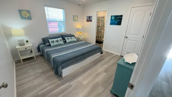 a bedroom with a bed and a window