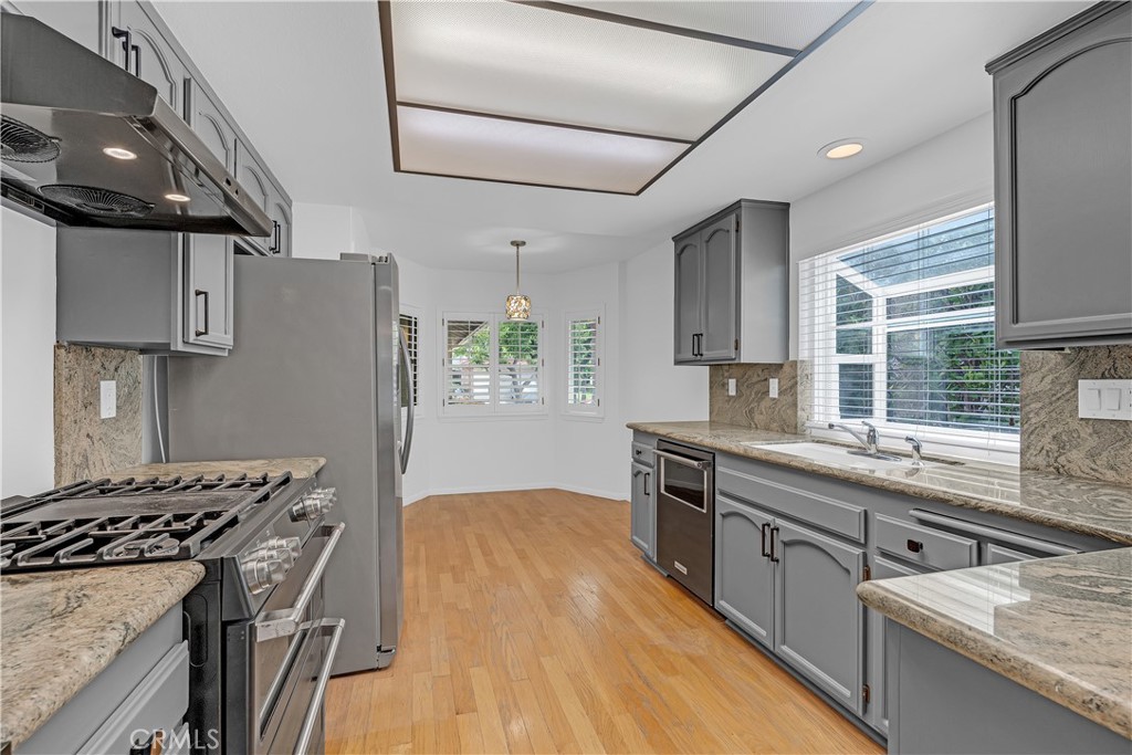 19451 Eagle Ridge Lane Porter Ranch, CA 91326 - Photo 25 of 59 a kitchen with stainless steel appliances granite countertop a sink stove and refrigerator