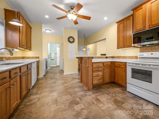 a kitchen with a sink stove and microwave
