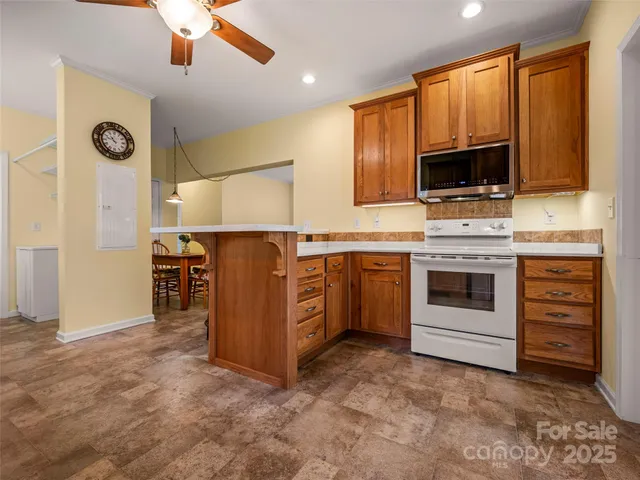 a kitchen with stainless steel appliances a stove sink and microwave