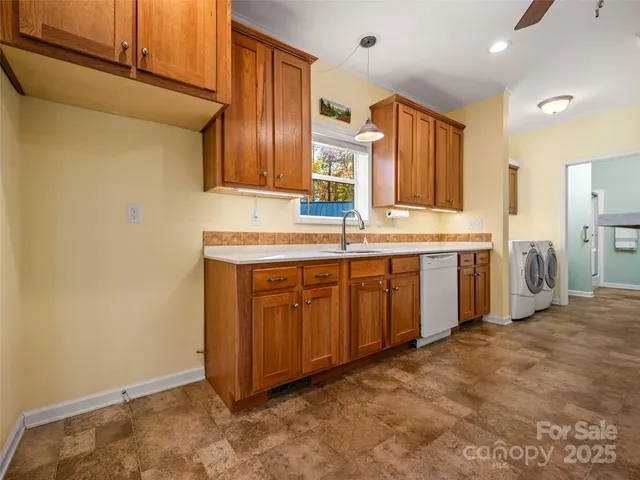 a view of a kitchen with stainless steel appliances granite countertop a sink stove and refrigerator