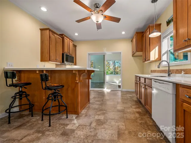 a open kitchen with stainless steel appliances granite countertop a sink and a refrigerator