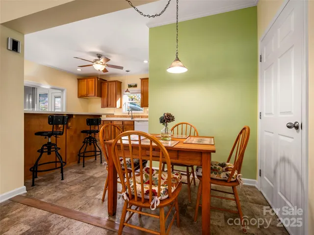 a view of a dining room with furniture and a chandelier