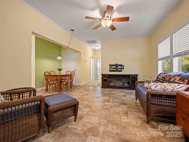 a living room with furniture and a chandelier